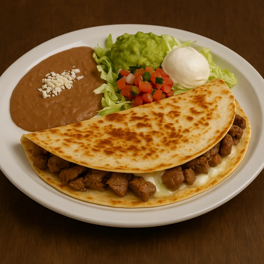 Quesadilla Mexicana at San Jose Mexican Restaurant with grilled flour tortilla, beef tips, cheese, refried beans, guacamole salad, tomato, lettuce, and sour cream on a white plate